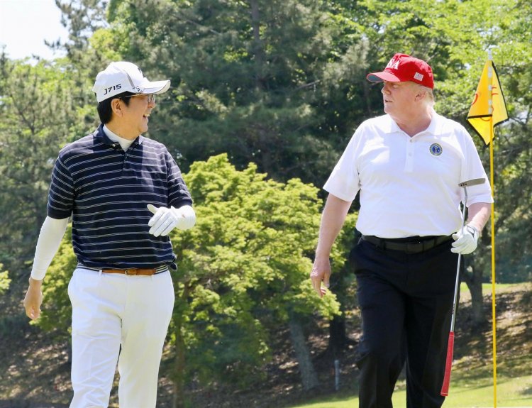 Trump downplays North Korea launches on Japan visit